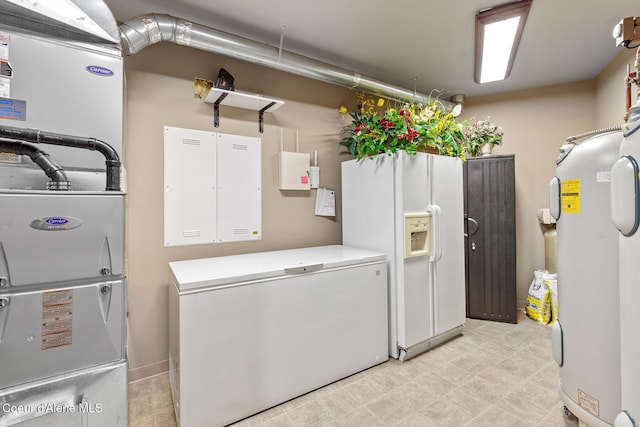 laundry room featuring water heater, light floors, laundry area, and washing machine and clothes dryer