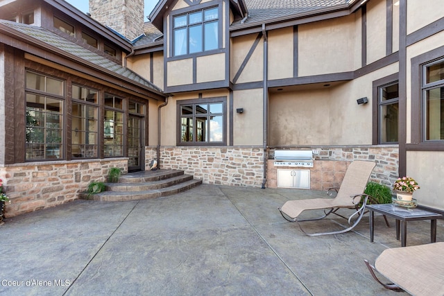 view of patio / terrace featuring area for grilling and a grill