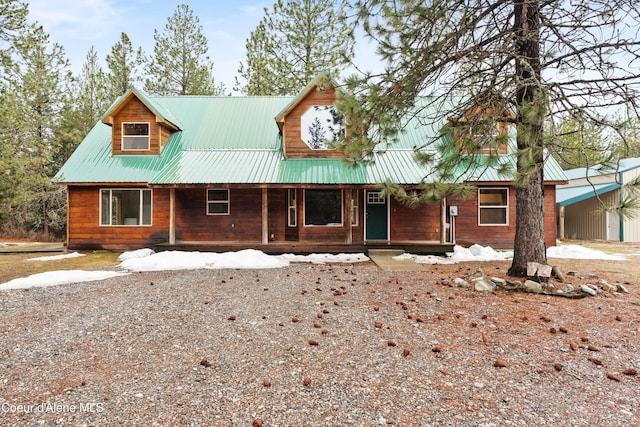 view of front of home with a porch and metal roof