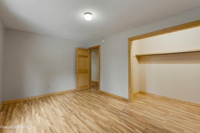 unfurnished bedroom with wood finished floors and baseboards