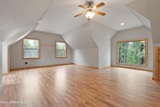 bonus room featuring vaulted ceiling, a ceiling fan, light wood-type flooring, and baseboards