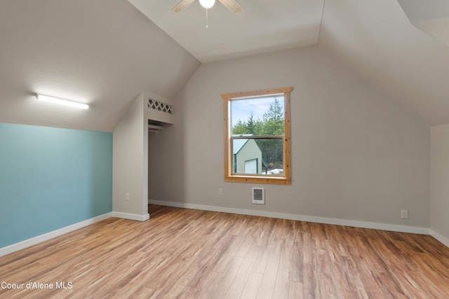 bonus room featuring visible vents, lofted ceiling, wood finished floors, and a ceiling fan