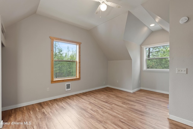 bonus room with visible vents, a ceiling fan, light wood finished floors, baseboards, and vaulted ceiling