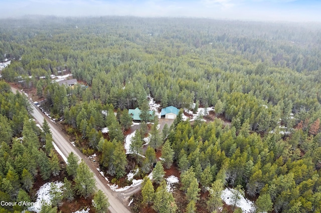 birds eye view of property featuring a view of trees