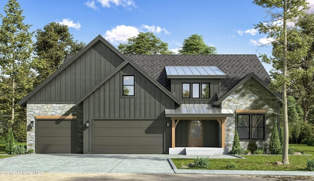 view of front facade with stone siding, board and batten siding, concrete driveway, and a shingled roof