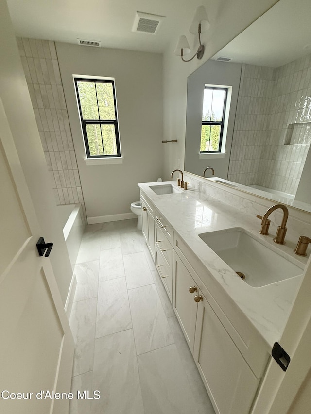 bathroom with marble look tile flooring, baseboards, toilet, a shower, and double vanity