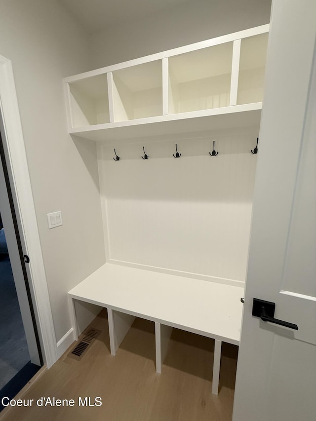 mudroom with wood finished floors and baseboards