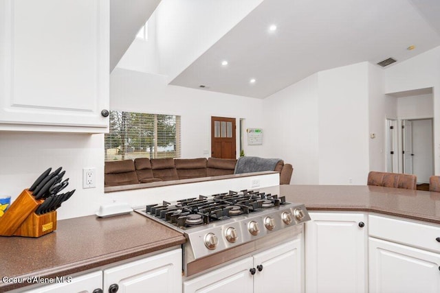 32722 N 10th Ave, Spirit Lake, ID 83869 - kitchen with stainless steel gas stovetop, white cabinetry, recessed lighting, dark countertops, and vaulted ceiling