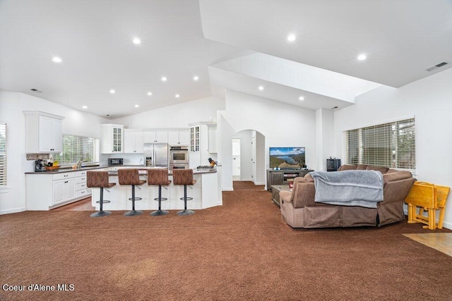 32722 N 10th Ave, Spirit Lake, ID 83869 - living room featuring dark colored carpet, recessed lighting, arched walkways, and high vaulted ceiling
