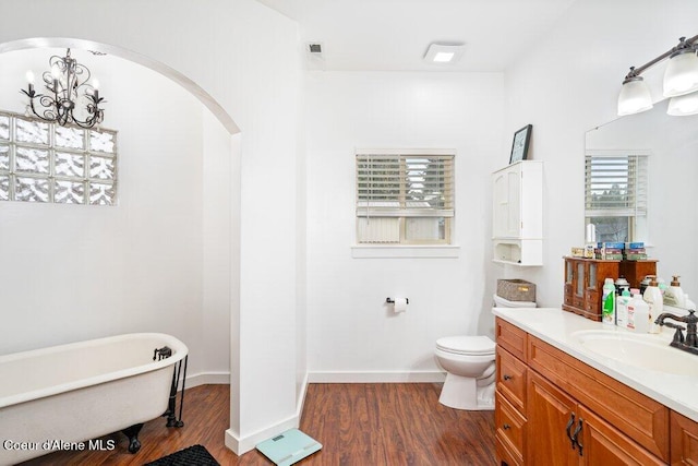 32722 N 10th Ave, Spirit Lake, ID 83869 - full bath with a soaking tub, vanity, wood finished floors, a chandelier, and toilet