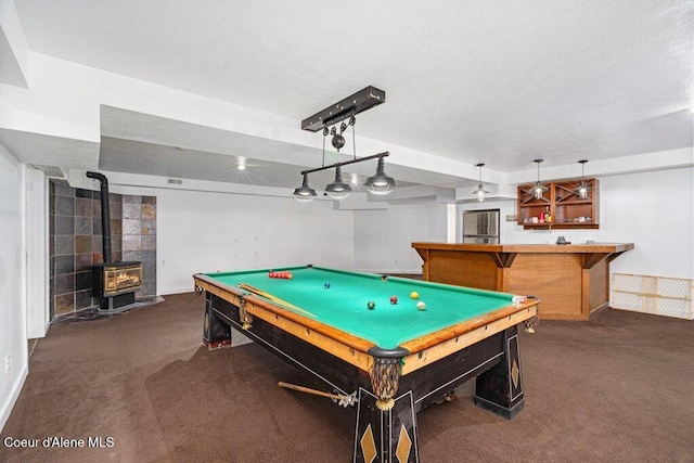 32722 N 10th Ave, Spirit Lake, ID 83869 - rec room featuring carpet floors, a wood stove, billiards table, baseboards, and bar area