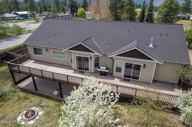 32722 N 10th Ave, Spirit Lake, ID 83869 - rear view of house with a wooden deck, roof with shingles, and a fire pit