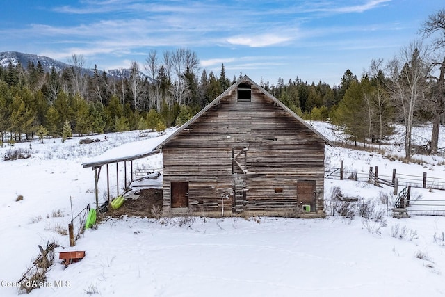 view of side of property featuring a garage, a barn, and an outdoor structure