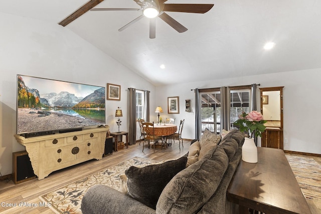 living room with baseboards, light wood-type flooring, ceiling fan, and vaulted ceiling