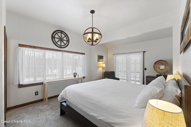 bedroom with lofted ceiling, carpet, baseboards, and a chandelier