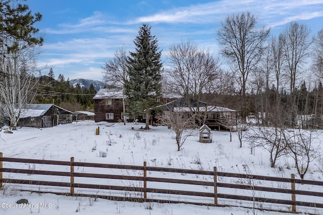 yard covered in snow featuring a fenced front yard