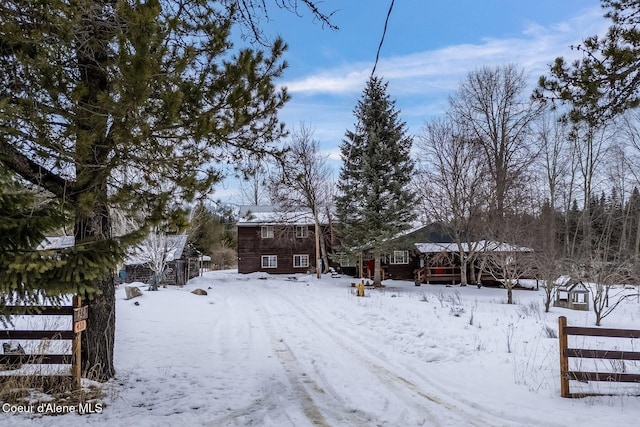 yard covered in snow with fence