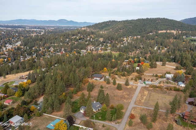 birds eye view of property with a mountain view and a wooded view