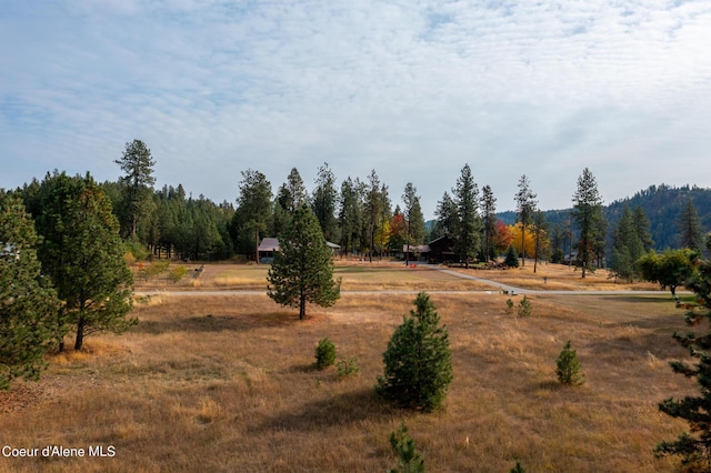 exterior space featuring a rural view and a wooded view