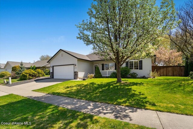 8920 N Torrey Ln, Hayden, ID 83835 - ranch-style home with an attached garage, a front lawn, fence, and concrete driveway