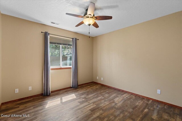 8920 N Torrey Ln, Hayden, ID 83835 - spare room featuring a ceiling fan, baseboards, visible vents, and wood finished floors