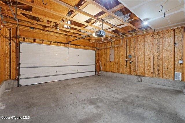 8920 N Torrey Ln, Hayden, ID 83835 - garage with a garage door opener and visible vents
