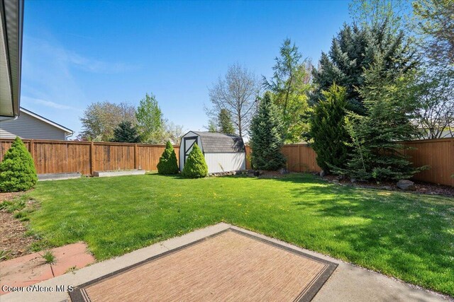 8920 N Torrey Ln, Hayden, ID 83835 - view of yard featuring an outbuilding, a shed, and a fenced backyard