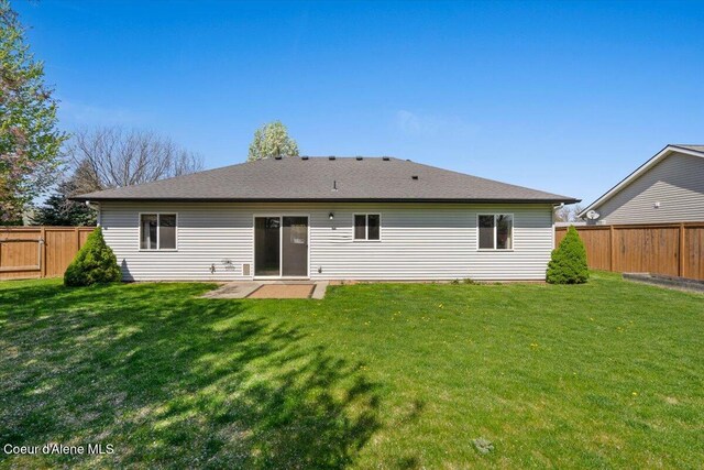 8920 N Torrey Ln, Hayden, ID 83835 - rear view of property featuring a lawn, a fenced backyard, and a patio area