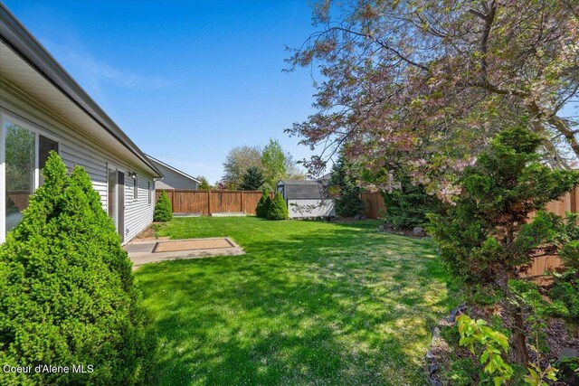 8920 N Torrey Ln, Hayden, ID 83835 - view of yard with a fenced backyard, a shed, and an outbuilding