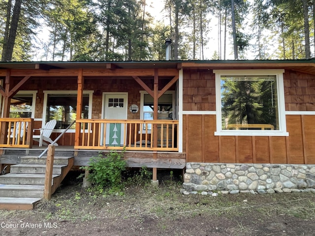 1942 Two Tail Rd, Bonners Ferry, ID 83805 - view of front of house featuring covered porch and stone siding