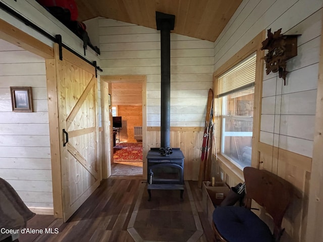 1942 Two Tail Rd, Bonners Ferry, ID 83805 - sunroom / solarium with a barn door, a wood stove, and lofted ceiling