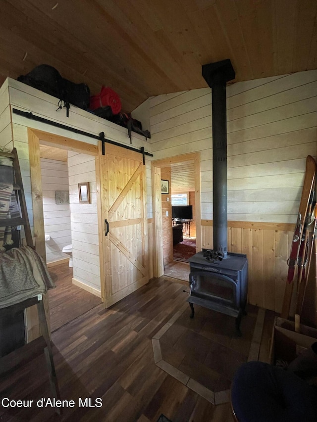 1942 Two Tail Rd, Bonners Ferry, ID 83805 - hallway with wood walls, wooden ceiling, lofted ceiling, wood finished floors, and a barn door