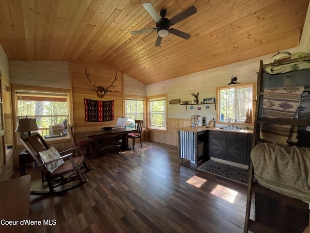 1942 Two Tail Rd, Bonners Ferry, ID 83805 - office area featuring wooden walls, vaulted ceiling, wood ceiling, dark wood-type flooring, and a ceiling fan