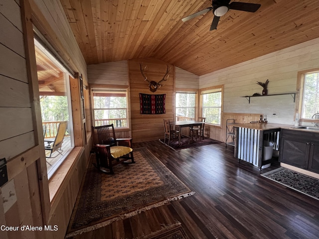 1942 Two Tail Rd, Bonners Ferry, ID 83805 - living area with wooden walls, vaulted ceiling, wood finished floors, wood ceiling, and plenty of natural light