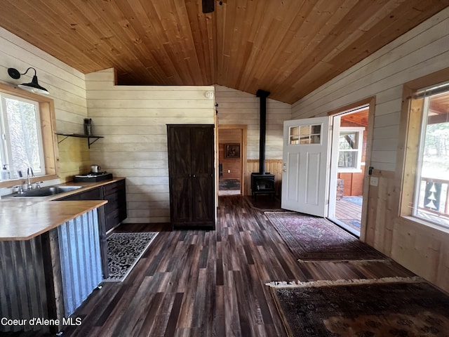 1942 Two Tail Rd, Bonners Ferry, ID 83805 - kitchen with wood walls, lofted ceiling, a wood stove, dark wood-style floors, and wooden ceiling