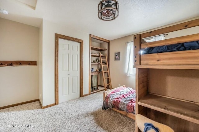 carpeted bedroom with baseboards