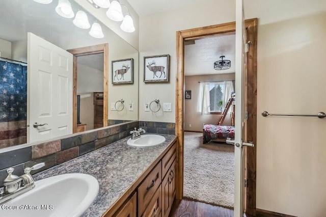 bathroom featuring double vanity, a sink, and ensuite bathroom