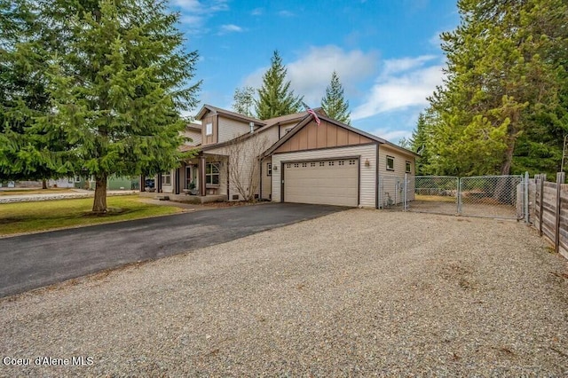 view of front of house with fence, driveway, an attached garage, and board and batten siding