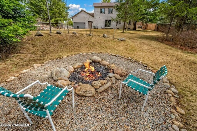 view of yard featuring a fire pit and fence
