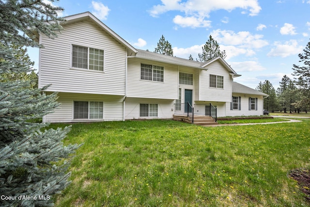 raised ranch with a front lawn