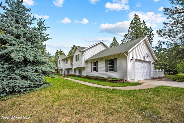 view of front of home featuring a front lawn, a garage, and concrete driveway