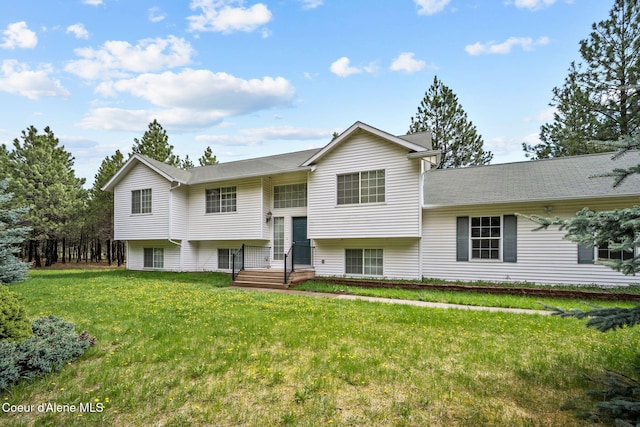 split foyer home with a front lawn