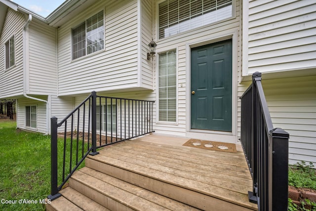 view of exterior entry with a yard
