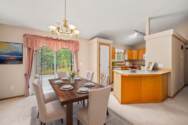 dining area with lofted ceiling, a wealth of natural light, light carpet, and a chandelier