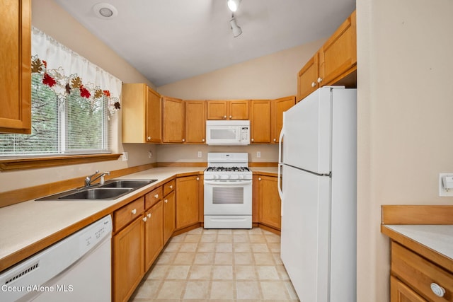 kitchen featuring light countertops, lofted ceiling, a sink, and white appliances