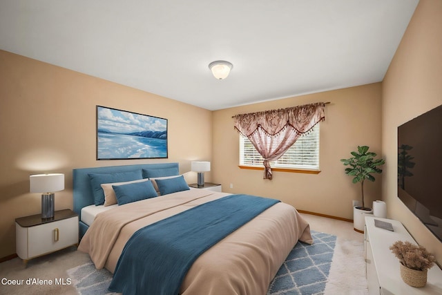 bedroom with baseboards and light carpet
