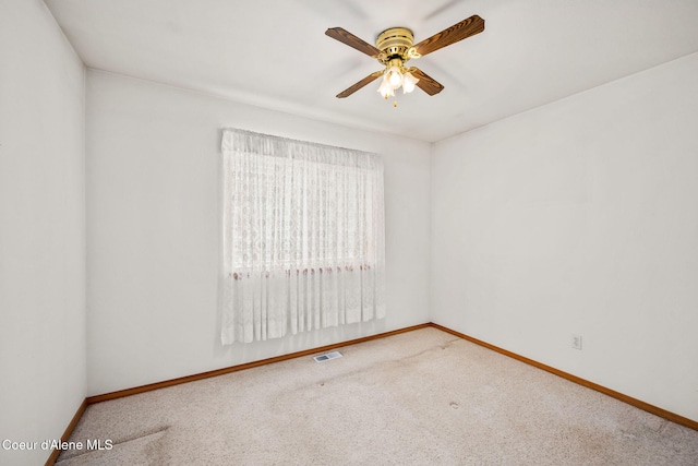 carpeted empty room featuring baseboards, a ceiling fan, and visible vents