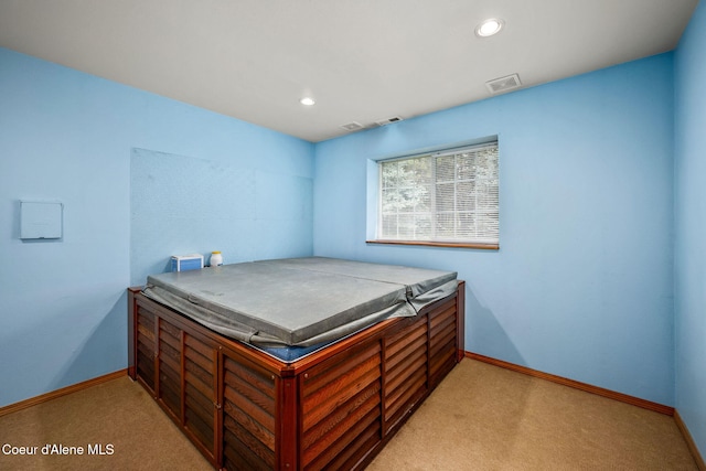 bedroom with light colored carpet, baseboards, and visible vents