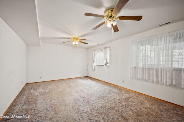 unfurnished room featuring baseboards, ceiling fan, visible vents, and carpet floors