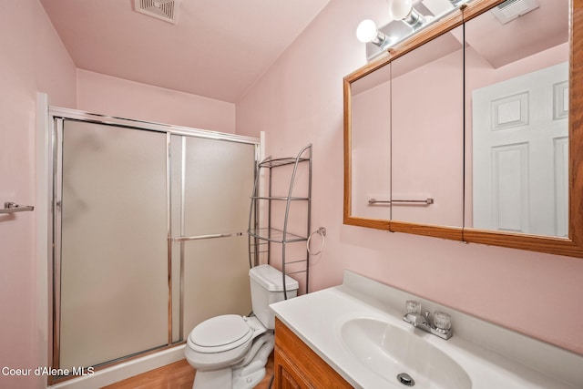 full bath featuring a shower stall, vanity, and visible vents